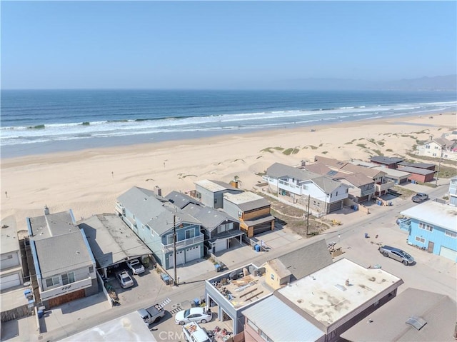 bird's eye view featuring a view of the beach and a water view