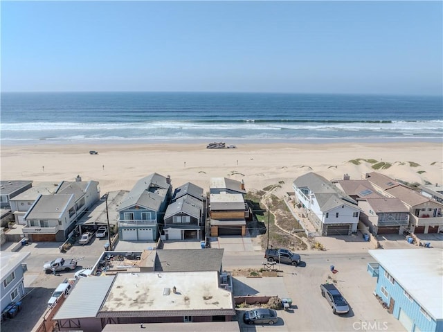 bird's eye view with a water view and a beach view