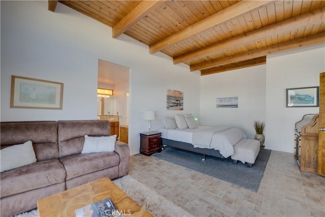 bedroom with ensuite bath, wooden ceiling, and beamed ceiling