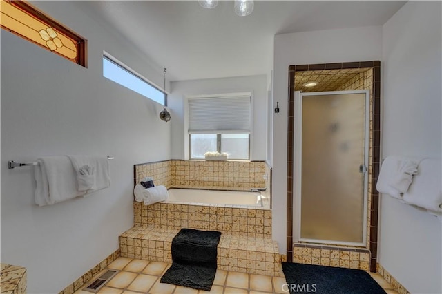 bathroom featuring tile patterned flooring and separate shower and tub