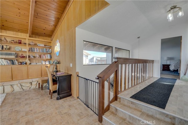 staircase featuring lofted ceiling, wood ceiling, and built in shelves