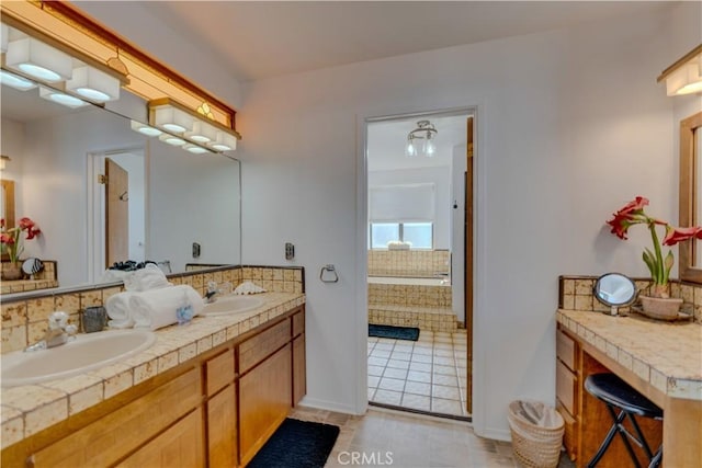 bathroom with vanity, tiled tub, decorative backsplash, and tile patterned floors