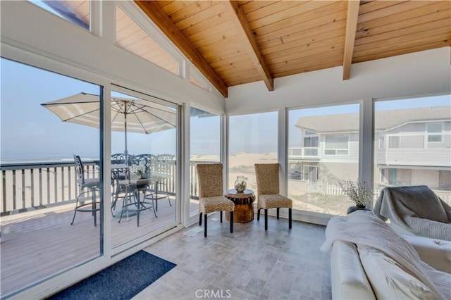 sunroom featuring a water view, vaulted ceiling with beams, wood ceiling, and plenty of natural light