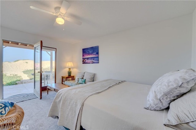 carpeted bedroom with a mountain view, access to outside, and ceiling fan