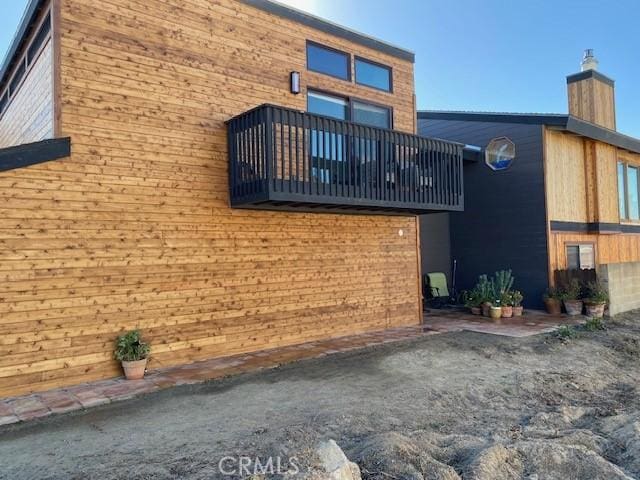 1612 Strand, Oceano, CA 93445 - view of side of property featuring a balcony and a chimney