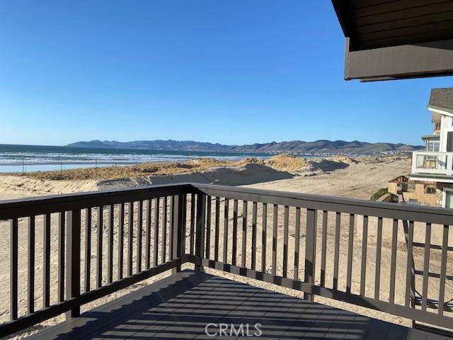 wooden terrace with a water and mountain view