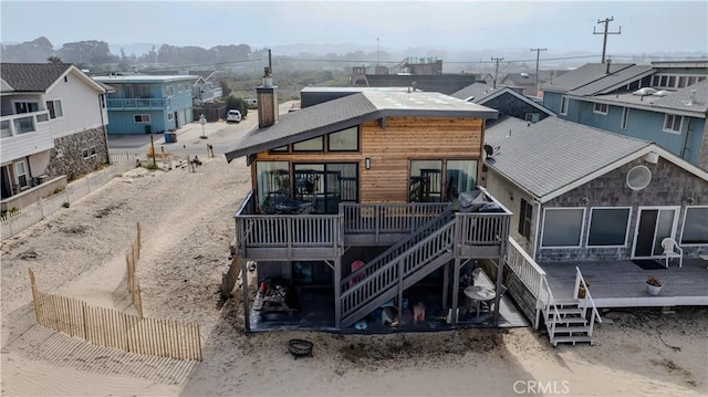 1612 Strand, Oceano, CA 93445 - view of front of house with a wooden deck, stairway, and a residential view