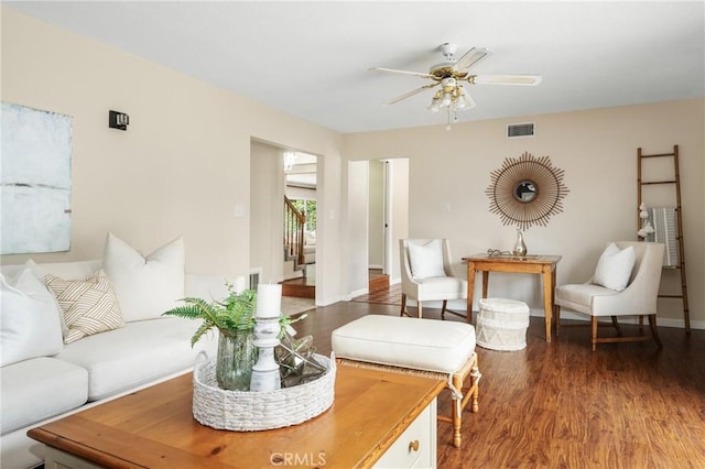 living room with dark wood-type flooring and ceiling fan