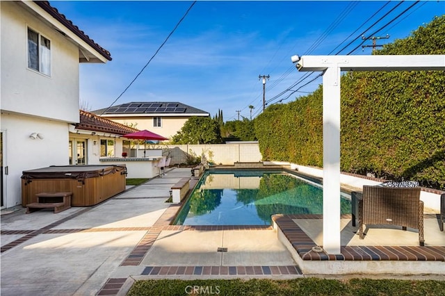 view of pool with a patio area and a hot tub