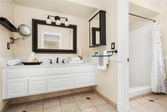 bathroom with curtained shower, vanity, and tile patterned flooring