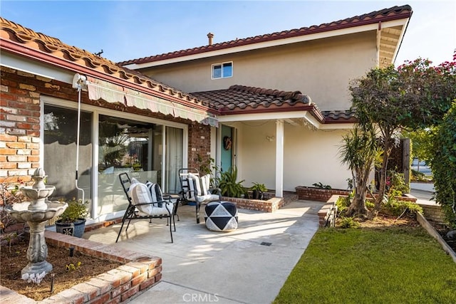 back of property with a patio