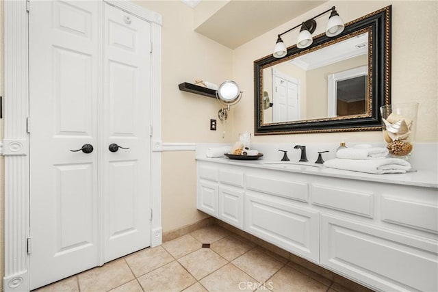 bathroom with ornamental molding, tile patterned floors, and vanity