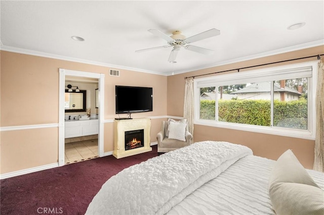 bedroom featuring ceiling fan, crown molding, connected bathroom, and carpet flooring