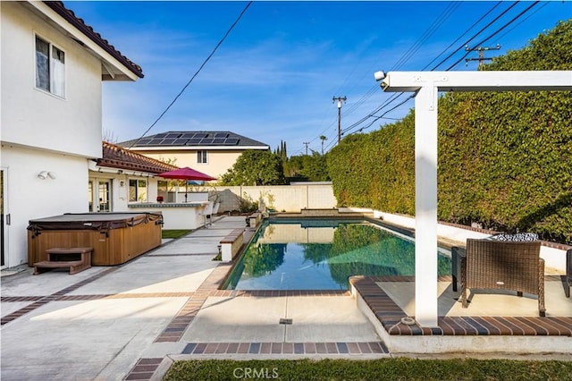 view of pool with a patio area and a hot tub