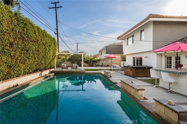 view of pool featuring a hot tub and a patio