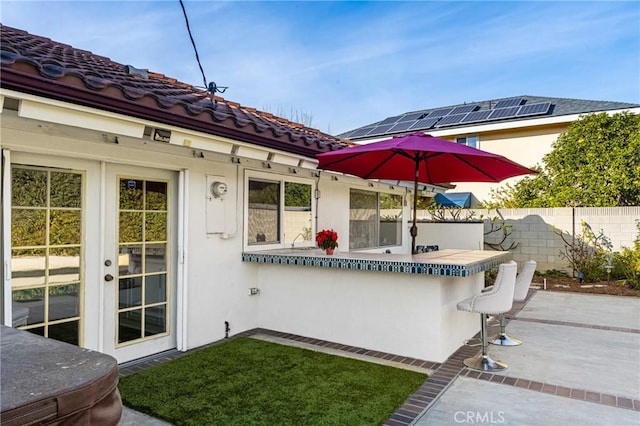 view of patio / terrace with a bar and french doors