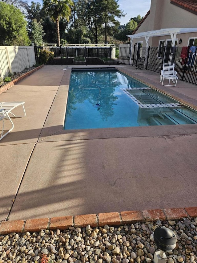 view of pool featuring a fenced in pool, fence, and a patio