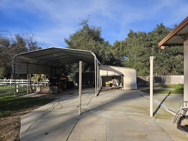 view of parking / parking lot featuring fence