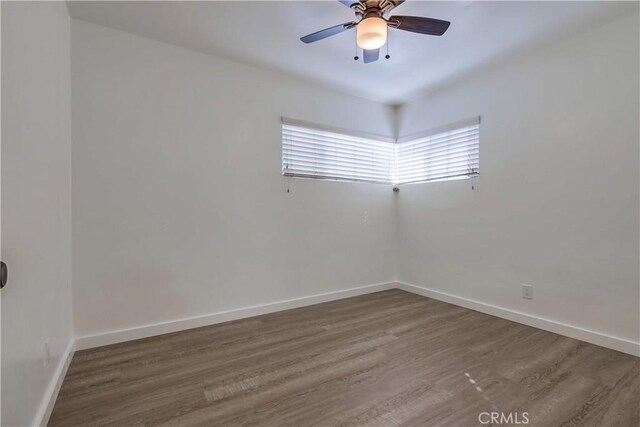 spare room with hardwood / wood-style floors and ceiling fan