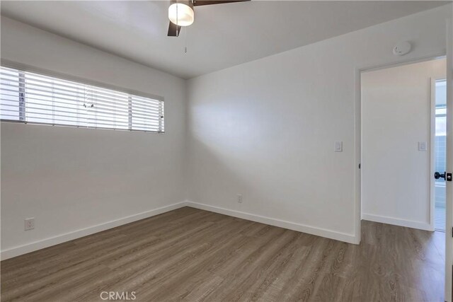 spare room featuring wood-type flooring and ceiling fan