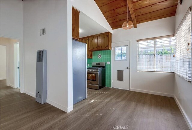 kitchen featuring vaulted ceiling with beams, wood ceiling, tasteful backsplash, wood-type flooring, and appliances with stainless steel finishes