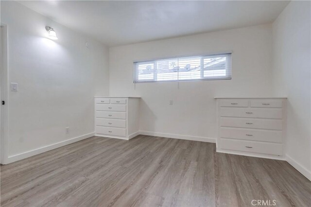 spare room featuring light hardwood / wood-style flooring