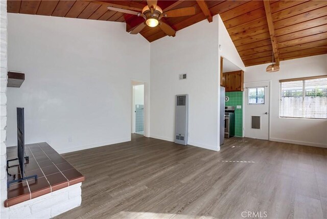 unfurnished living room with wood-type flooring, wooden ceiling, lofted ceiling with beams, and ceiling fan