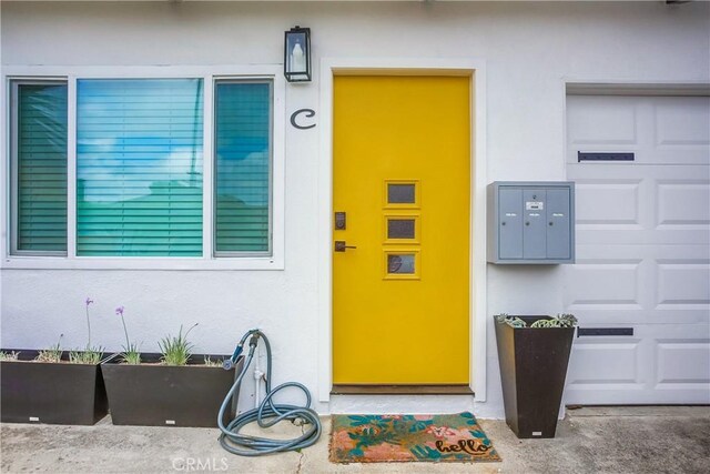 view of exterior entry with a garage