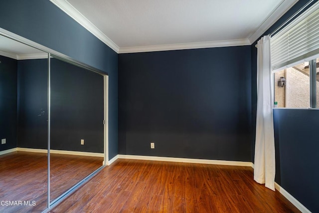 unfurnished bedroom featuring a closet, crown molding, and hardwood / wood-style flooring