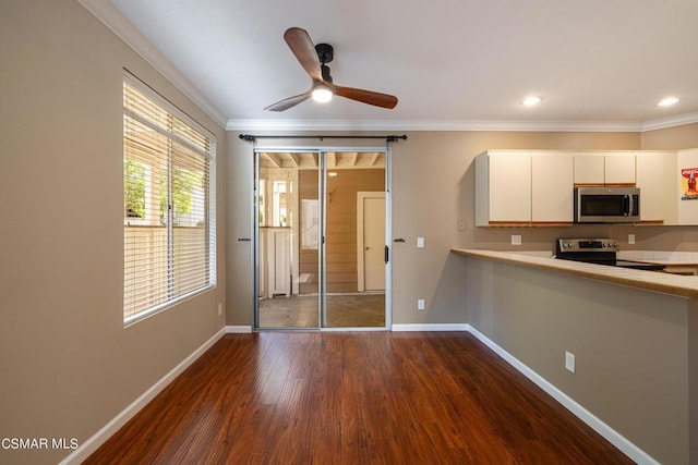 kitchen featuring stainless steel appliances, crown molding, dark hardwood / wood-style flooring, and white cabinetry