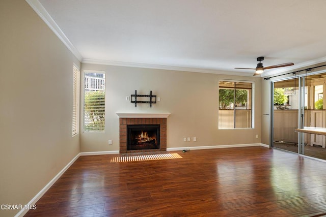 unfurnished living room with ceiling fan, dark hardwood / wood-style floors, crown molding, and a fireplace