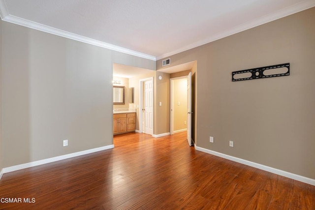 spare room with wood-type flooring and crown molding