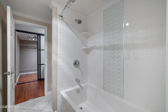 bathroom with tiled shower / bath, tile patterned floors, and ornamental molding