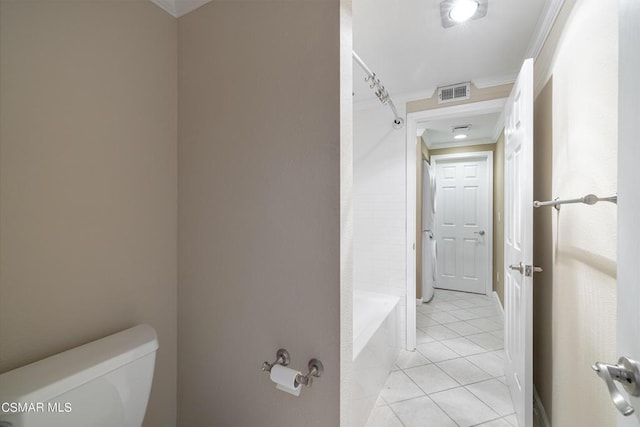 bathroom featuring toilet, ornamental molding, and tile patterned floors