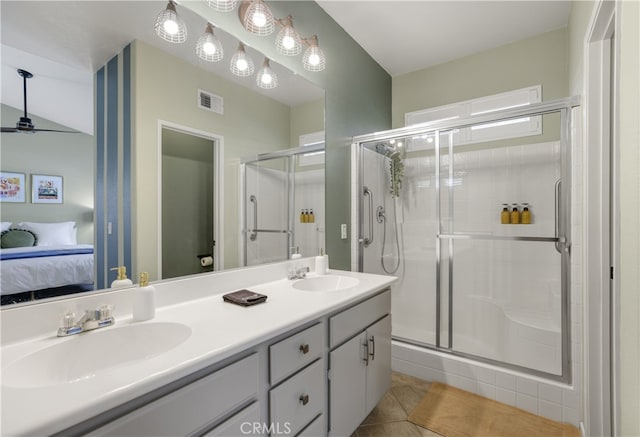 ensuite bathroom with visible vents, a shower stall, a sink, and ensuite bathroom