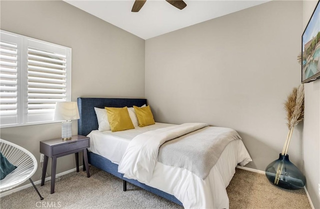 carpeted bedroom featuring baseboards and ceiling fan