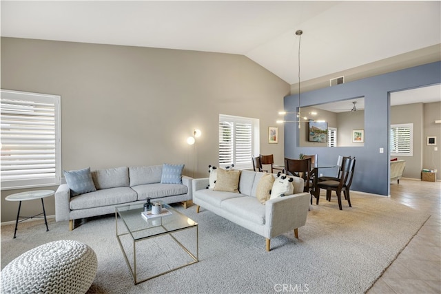 living room featuring high vaulted ceiling, baseboards, and visible vents