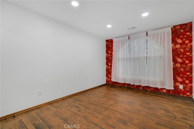 unfurnished room featuring dark hardwood / wood-style floors