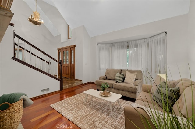 living room featuring hardwood / wood-style flooring and vaulted ceiling