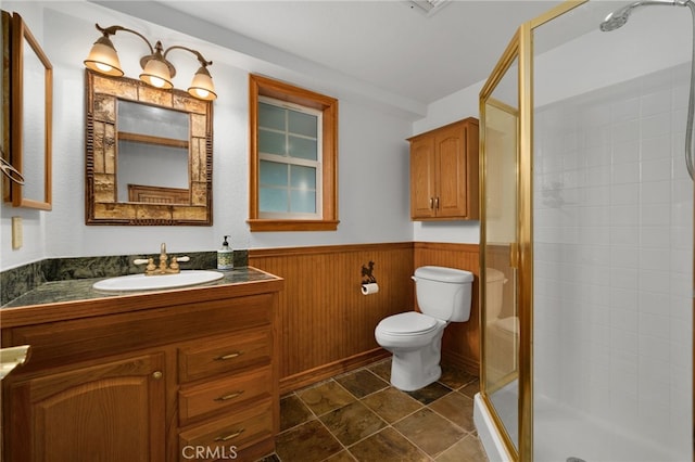 bathroom with vanity, toilet, and an enclosed shower