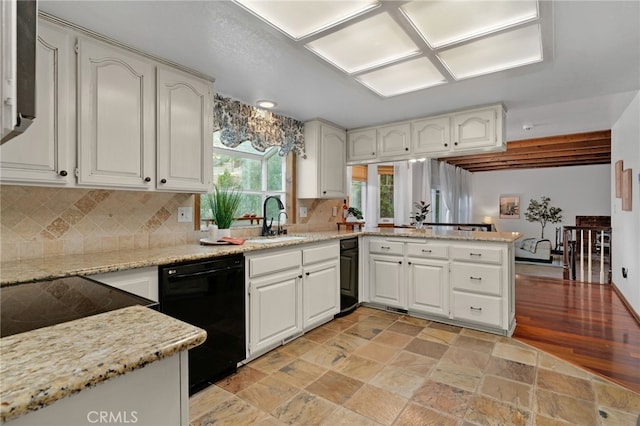 kitchen with sink, black dishwasher, backsplash, kitchen peninsula, and white cabinets