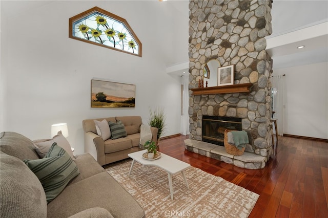 living room featuring a fireplace, hardwood / wood-style floors, and a high ceiling