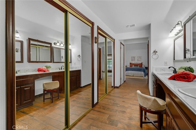 bathroom with vanity and hardwood / wood-style flooring