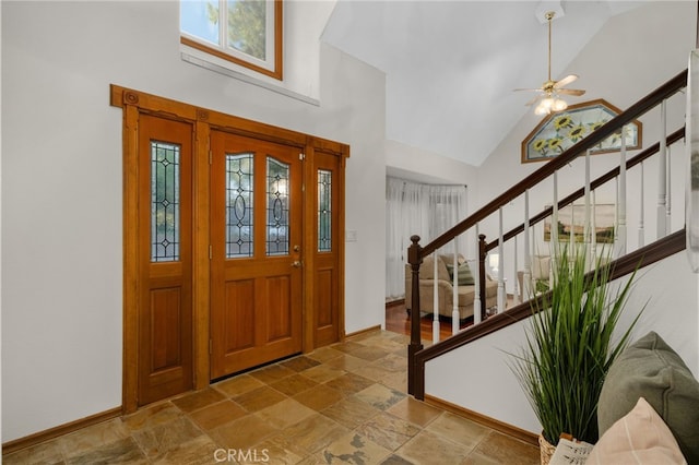 foyer with ceiling fan and high vaulted ceiling