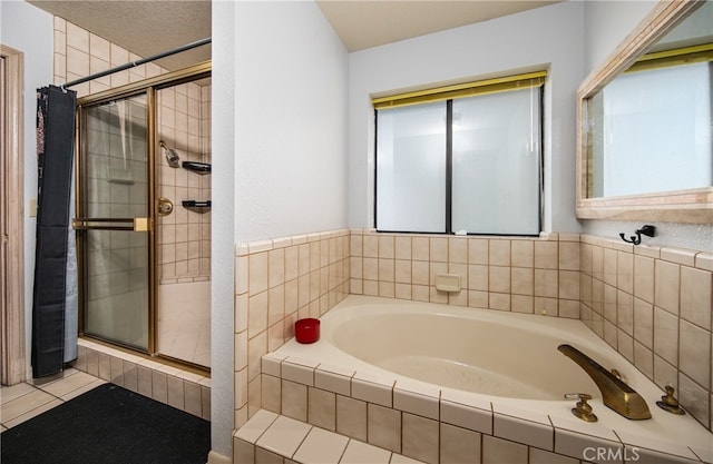 bathroom with tile patterned flooring, a textured ceiling, and independent shower and bath