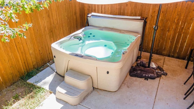 view of patio / terrace with a hot tub