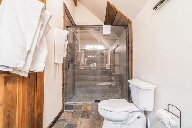 bathroom with toilet and an enclosed shower