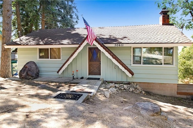 30611 Ferndale Dr, Running Springs, CA 92382 - view of front facade with a chimney and roof with shingles
