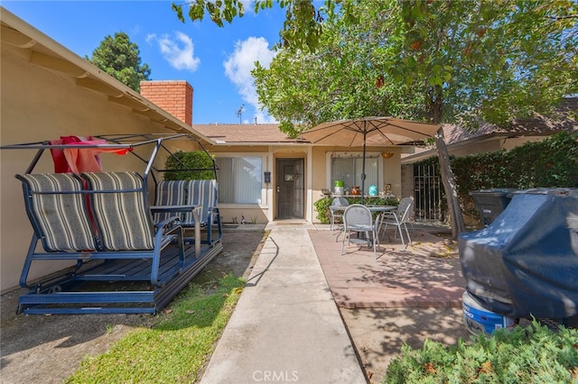 property entrance featuring a patio area