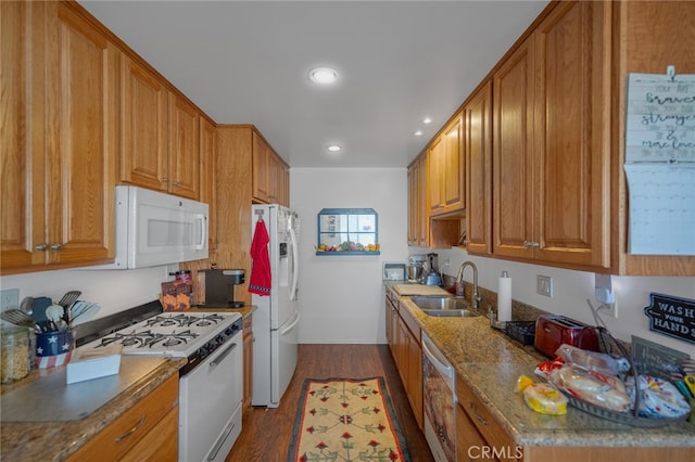 kitchen featuring dark hardwood / wood-style floors, sink, white appliances, and stone countertops